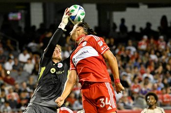 Jul 26, 2025; Chicago, Illinois, USA;  Chicago Fire goalkeeper Chris Brady (1) and defender Omar González (34) defend against the New York Red Bulls during the second half at Soldier Field. Mandatory Credit: Matt Marton-Imagn Images