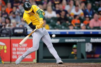 Jul 27, 2025; Houston, Texas, USA;  Athletics left fielder Brent Rooker (25) hits a single against the Houston Astros during the fourth inning at Daikin Park. Mandatory Credit: Erik Williams-Imagn Images