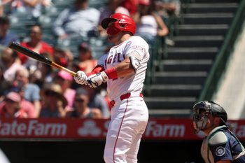 Jul 27, 2025; Anaheim, California, USA;  Los Angeles Angels designated hitter Mike Trout (27) hits a two-run home run for his 1,000th career RBI during the fifth inning against the Seattle Mariners at Angel Stadium. Mandatory Credit: Kiyoshi Mio-Imagn Images
