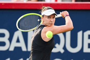 Jul 27, 2025; Montreal, QC, Canada; Barbora Krejcikova (CZE) returns the ball against Bianca Andreescu (CAN) in first round play at IGA Stadium. Mandatory Credit: David Kirouac-Imagn Images