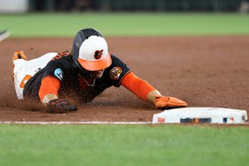 Jul 28, 2025; Baltimore, Maryland, USA; Baltimore Orioles shortstop Gunnar Henderson (2) slides into third base safely during the sixth inning against the Toronto Blue Jays at Oriole Park at Camden Yards. Mandatory Credit: Daniel Kucin Jr.-Imagn Images