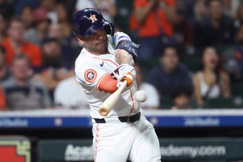 Jul 29, 2025; Houston, Texas, USA; Houston Astros designated hitter Jose Altuve (27) hits an RBI single during the sixth inning against the Washington Nationals at Daikin Park. Mandatory Credit: Troy Taormina-Imagn Images