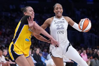 Jul 29, 2025; Los Angeles, California, USA; Las Vegas Aces center A'ja Wilson (22) dribbles the ball against LA Sparks forward Dearica Hamby (5) in the second half at the Crypto.com Arena. Mandatory Credit: Kirby Lee-Imagn Images
