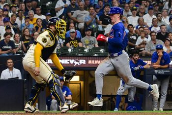 Jul 30, 2025; Milwaukee, Wisconsin, USA; Chicago Cubs center fielder Pete Crow-Armstrong (4) scores on a sacrifice fly in the ninth inning as Milwaukee Brewers catcher William Contreras (24) looks on at American Family Field. Mandatory Credit: Benny Sieu-Imagn Images