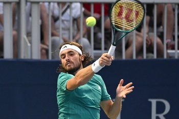 Jul 30, 2025; Toronto, ON, Canada;  Stefanos Tsitsipas (GRE) plays a shot against Christopher O'Connell (AUS) during second round play at Sobeys Stadium. Mandatory Credit: Dan Hamilton-Imagn Images