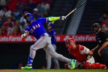 Jul 30, 2025; Anaheim, California, USA; Texas Rangers right fielder Adolis García (53) hits a two run home run against the Los Angeles Angels during the eighth inning at Angel Stadium. Mandatory Credit: Gary A. Vasquez-Imagn Images