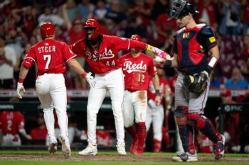 Cincinnati Reds shortstop Elly De La Cruz (44) high fives Cincinnati Reds first baseman Spencer Steer (7) after he hit a 3-run home in the eighth inning between Cincinnati Reds and Atlanta Braves at Great American Ball Park in Cincinnati on July 30, 2025.