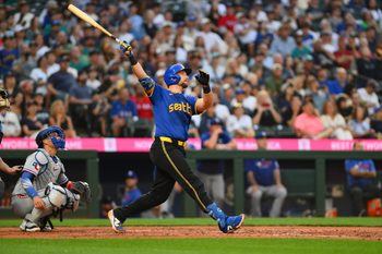 Jul 31, 2025; Seattle, Washington, USA; Seattle Mariners catcher Cal Raleigh (29) hits a home run against the Texas Rangers during the fifth inning at T-Mobile Park. Mandatory Credit: Steven Bisig-Imagn Images