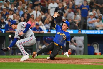 Jul 31, 2025; Seattle, Washington, USA; Seattle Mariners second baseman Cole Young (2) scores a run past Texas Rangers relief pitcher Jacob Latz (67) on a passed ball during the sixth inning at T-Mobile Park. Mandatory Credit: Steven Bisig-Imagn Images