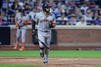 Aug 1, 2025; New York City, New York, USA; San Francisco Giants pinch hitter Dominic Smith (7) watches his RBI single against the New York Mets during the tenth inning at Citi Field. Mandatory Credit: Brad Penner-Imagn Images
