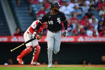 Aug 1, 2025; Anaheim, California, USA; Chicago White Sox center fielder Luis Robert Jr. (88) hits a sacrifice RBI against the Los Angeles Angels during the fourth inning at Angel Stadium. Mandatory Credit: Gary A. Vasquez-Imagn Images
