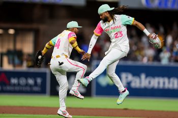 Aug 1, 2025; San Diego, California, USA; San Diego Padres right fielder Fernando Tatis Jr. (23) and first baseman Luis Arraez (4) high five after defeating the St. Louis Cardinals at Petco Park. Mandatory Credit: Chadd Cady-Imagn Images