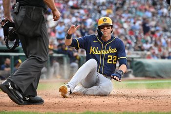 Aug 2, 2025; Washington, District of Columbia, USA; Milwaukee Brewers left fielder Christian Yelich (22) slides into home plate to score a run against the Washington Nationals during the ninth inning at Nationals Park. Mandatory Credit: Rafael Suanes-Imagn Images