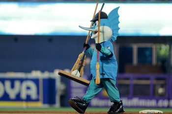 Aug 3, 2025; Miami, Florida, USA; Miami Marlins mascot Billy the Marlins walks with three brooms after the Miami Marlins swept the New York Yankees at loanDepot Park. Mandatory Credit: Sam Navarro-Imagn Images