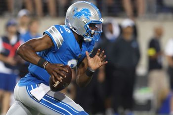 Jul 31, 2025; Canton, Ohio, USA;  Detroit Lions quarterback Hendon Hooker (2) scrambles with the ball  against the Los Angeles Chargers during the second half at Tom Benson Hall of Fame Stadium. Mandatory Credit: Charles LeClaire-Imagn Images