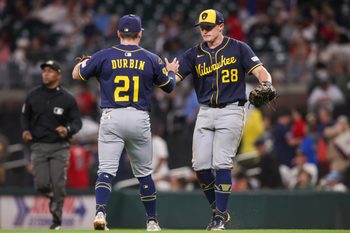 Aug 4, 2025; Atlanta, Georgia, USA; Milwaukee Brewers third baseman Caleb Durbin (21) and first baseman Andrew Vaughn (28) celebrate after a victory over the Atlanta Braves in the ninth inning at Truist Park. Mandatory Credit: Brett Davis-Imagn Images