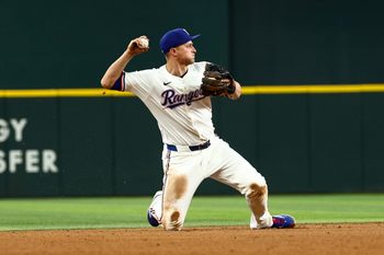 Aug 5, 2025; Arlington, Texas, USA;  Texas Rangers shortstop Corey Seager (5) makes a diving stop to start a double play during the ninth inning against the New York Yankees at Globe Life Field. Mandatory Credit: Kevin Jairaj-Imagn Images