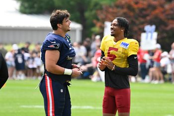 Aug 6, 2025; Foxborough, MA, USA; New England Patriots offensive tackle Will Campbell (66) and Washington Commanders quarterback Jayden Daniels (5) talk after training camp at Gillette Stadium. Mandatory Credit: Eric Canha-Imagn Images