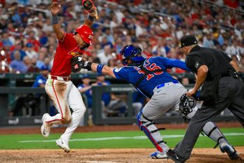 Aug 8, 2025; St. Louis, Missouri, USA;  St. Louis Cardinals shortstop Masyn Winn (0) is tagged out by Chicago Cubs catcher Carson Kelly (15) during the eighth inning at Busch Stadium. Mandatory Credit: Jeff Curry-Imagn Images