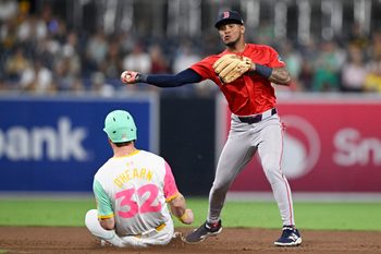 Aug 8, 2025; San Diego, California, USA; Boston Red Sox center fielder Ceddanne Rafaela (3) throws over San Diego Padres first baseman Ryan O'Hearn (32) as he tries to turn a double play during the eighth inning at Petco Park. Mandatory Credit: Denis Poroy-Imagn Images