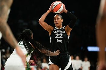 Aug 8, 2025; Las Vegas, Nevada, USA; Las Vegas Aces center A'ja Wilson (22) controls the ball against Seattle Storm forward Ezi Magbegor (13) during the first half of a WNBA basketball game at Michelob Ultra Arena. Mandatory Credit: Lucas Peltier-Imagn Images