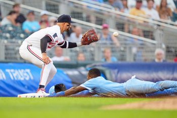 Aug 9, 2025; Minneapolis, Minnesota, USA; Kansas City Royals second base Tyler Tolbert (2) slides into third base as the ball reaches Minnesota Twins catcher Ryan Jeffers (27) in the seventh inning at Target Field. Mandatory Credit: Matt Blewett-Imagn Images