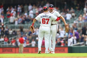 Aug 10, 2025; Cumberland, Georgia, USA; Atlanta Braves shortstop Nacho Alvarez Jr. (67) and first baseman Matt Olson (28) hug after a win against the Miami Marlins at Truist Park. Mandatory Credit: Jordan Godfree-Imagn Images