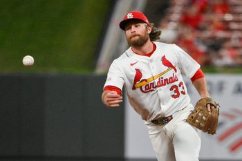 Aug 11, 2025; St. Louis, Missouri, USA;  St. Louis Cardinals second baseman Brendan Donovan (33) flips the ball to first base during the ninth inning against the Colorado Rockies at Busch Stadium. Mandatory Credit: Jeff Curry-Imagn Images