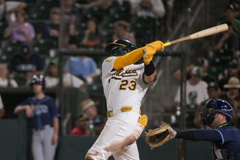 Aug 11, 2025; West Sacramento, California, USA; Athletics catcher Shea Langeliers (23) hits a home run against the Tampa Bay Rays during the fifth inning at Sutter Health Park. Mandatory Credit: Ed Szczepanski-Imagn Images