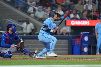 Aug 12, 2025; Toronto, Ontario, CAN; Toronto Blue Jays centre fielder Daulton Varsho (5) hits a single against the Chicago Cubs during the fifth inning at Rogers Centre. Mandatory Credit: Nick Turchiaro-Imagn Images