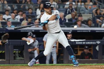 Aug 12, 2025; Bronx, New York, USA; New York Yankees right fielder Giancarlo Stanton (27) hits a two-run single during the seventh inning against the Minnesota Twins at Yankee Stadium. Mandatory Credit: Vincent Carchietta-Imagn Images