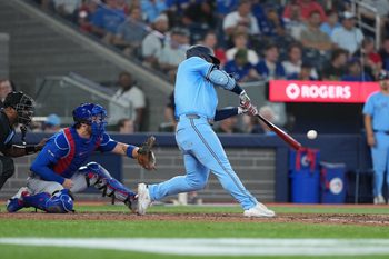 Aug 12, 2025; Toronto, Ontario, CAN; Toronto Blue Jays centre fielder Daulton Varsho (5) hits a home run against the Chicago Cubs during the eighth inning at Rogers Centre. Mandatory Credit: Nick Turchiaro-Imagn Images