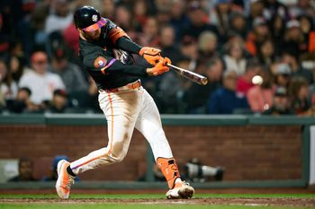 Aug 12, 2025; San Francisco, California, USA; San Francisco Giants second baseman Casey Schmitt (10) hits a single against the San Diego Padres during the fifth inning at Oracle Park. Mandatory Credit: Robert Edwards-Imagn Images
