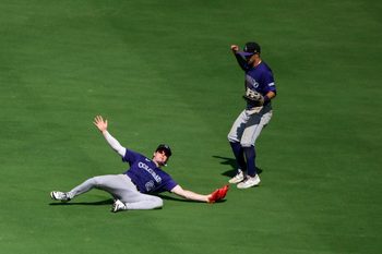 Aug 13, 2025; St. Louis, Missouri, USA;  Colorado Rockies center fielder Mickey Moniak (22) dives and catches a line drive hit by St. Louis Cardinals catcher Pedro Pages (not pictured) during the ninth inning at Busch Stadium. Mandatory Credit: Jeff Curry-Imagn Images