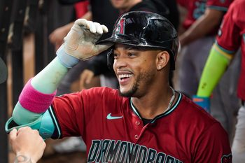 Aug 13, 2025; Arlington, Texas, USA; Arizona Diamondbacks second baseman Ketel Marte (4) is greeted in the dugout after hitting a three-run home run during the ninth inning against the Texas Rangers at Globe Life Field. Mandatory Credit: Raymond Carlin III-Imagn Images