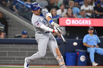 Aug 13, 2025; Toronto, Ontario, CAN;  Chicago Cubs designated hitter Seiya Suzuki (27) hits an RBI single against the Toronto Blue Jays in the eighth inning at Rogers Centre. Mandatory Credit: Dan Hamilton-Imagn Images