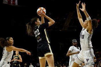 Aug 13, 2025; Washington, District of Columbia, USA; Washington Mystics guard Sonia Citron (22) is fouled while scoring by Golden State Valkyries forward Janelle Salaun (13) as Valkyries guard Veronica Burton (22) defends in the second half at CareFirst Arena. Mandatory Credit: Geoff Burke-Imagn Images