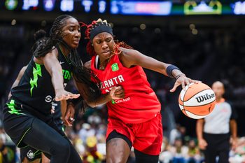 Aug 13, 2025; Seattle, Washington, USA; Atlanta Dream guard Rhyne Howard (10) dribbles against Seattle Storm forward Ezi Magbegor (13) during the fourth quarter at Climate Pledge Arena. Mandatory Credit: Joe Nicholson-Imagn Images