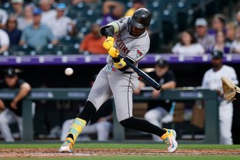 Aug 14, 2025; Denver, Colorado, USA; Arizona Diamondbacks shortstop Geraldo Perdomo (2) hits a single in the fourth inning against the Colorado Rockies at Coors Field. Mandatory Credit: Isaiah J. Downing-Imagn Images