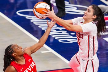 Indiana Fever guard Kelsey Mitchell (0) and Washington Mystics guard Sonia Citron (22) go for the ball Friday, Aug. 15, 2025, during a game between the Indiana Fever and the Washington Mystics at Gainbridge Fieldhouse in Indianapolis.
