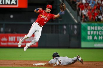 Aug 15, 2025; St. Louis, Missouri, USA;  St. Louis Cardinals shortstop Masyn Winn (0) leaps to field the throw and tags out New York Yankees left fielder Jasson Dominguez (24) during the third inning at Busch Stadium. Mandatory Credit: Jeff Curry-Imagn Images