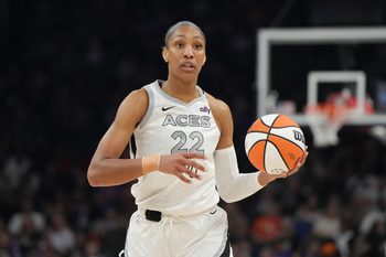 Aug 15, 2025; Phoenix, Arizona, USA; Las Vegas Aces center A'ja Wilson (22) brings the ball up court against the Phoenix Mercury in the first half at Footprint Center. Mandatory Credit: Rick Scuteri-Imagn Images
