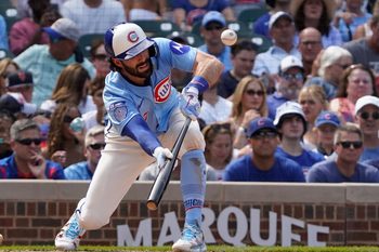 Aug 15, 2025; Chicago, Illinois, USA; Chicago Cubs shortstop Dansby Swanson (7) lays down a sacrifice bunt against the Pittsburgh Pirates during the seventh inning at Wrigley Field. Mandatory Credit: David Banks-Imagn Images
