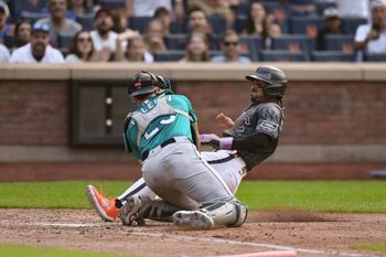 Aug 16, 2025; New York City, New York, USA; New York Mets shortstop Francisco Lindor (12) is tagged out at home plate by Seattle Mariners catcher Cal Raleigh (29) during the seventh inning at Citi Field. Mandatory Credit: John Jones-Imagn Images