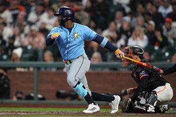 Aug 16, 2025; San Francisco, California, USA; Tampa Bay Rays designated hitter Yandy Diaz (2) hits an RBI single against the San Francisco Giants during the eighth inning at Oracle Park. Mandatory Credit: Darren Yamashita-Imagn Images