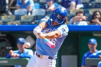 Aug 17, 2025; Kansas City, Missouri, USA; Kansas City Royals left fielder Adam Frazier (26) hits a double against the Chicago White Sox in the seventh inning at Kauffman Stadium. Mandatory Credit: Denny Medley-Imagn Images