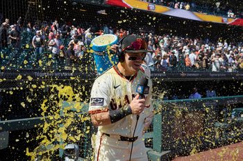 Aug 17, 2025; San Francisco, California, USA; San Francisco Giants shortstop Willy Adames (2) (obscured) dumps a cooler of sports drink over right fielder Drew Gilbert (61) to celebrate the Giants defeat of the Tampa Bay Rays in the ninth inning at Oracle Park. Mandatory Credit: Robert Edwards-Imagn Images