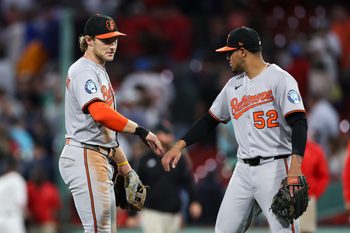 Aug 18, 2025; Boston, Massachusetts, USA; Baltimore Orioles shortstop Gunnar Henderson (2) and Baltimore Orioles shortstop Luis Vazquez (52) celebrate after defeating the Boston Red Sox at Fenway Park. Mandatory Credit: Paul Rutherford-Imagn Images
