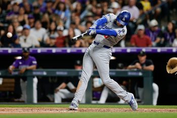 Aug 18, 2025; Denver, Colorado, USA; Los Angeles Dodgers first baseman Freddie Freeman (5) hits a double in the eighth inning against the Colorado Rockies at Coors Field. Mandatory Credit: Isaiah J. Downing-Imagn Images