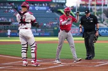Aug 18, 2025; Anaheim, California, USA; Cincinnati Reds designated hitter Gavin Lux (2) crosses home plate after hitting a two-run home run in the first inning as Los Angeles Angels catcher Logan O'Hoppe (14) and home plate umpire Chris Conroy watch at Angel Stadium. Mandatory Credit: Kirby Lee-Imagn Images